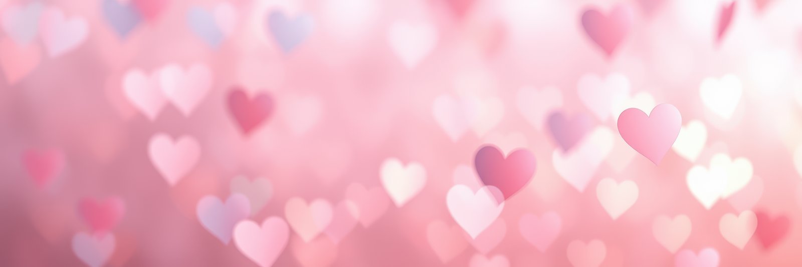 Romantic background featuring soft heart shapes in shades of pink and red for celebrations or love-themed events